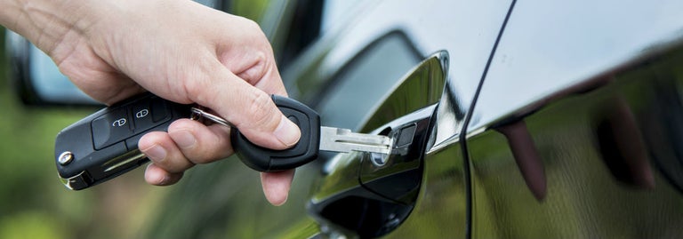 Individual unlocking car with keys