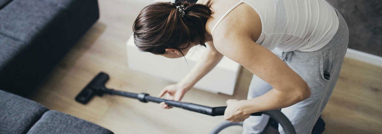 women cleaning with vacuum cleaner